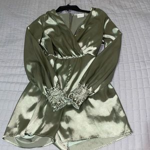 Francesca’s Satin, Sage Romper with open back and deep V collar.